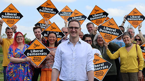 Ian Sollom with volunteers in the background