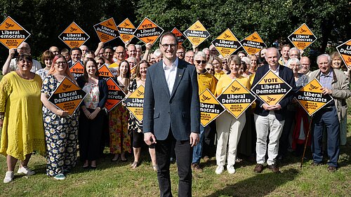 Ian Sollom, pictured at his launch event in August 2023 with a crowd of Liberal Democrat volunteers in the background